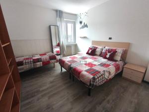 a bedroom with a bed and a mirror in it at Superior Apartments Giovannini in Fai della Paganella