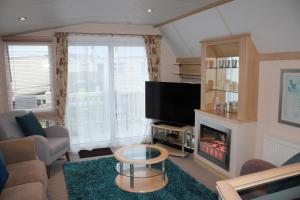 a living room with a tv and a fireplace at Golden sands ingoldmells plot 337 in Skegness