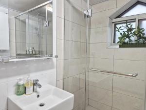a bathroom with a shower and a sink and a mirror at Maison Stay in Samgong +33 photos