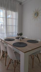 a wooden table with chairs and a vase with a plant on it at Casa Trastévere in San Juan de los Terreros