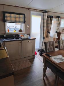 a kitchen with a sink and a table at St Minver Hideaway in Saint Minver