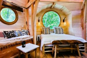 a bedroom with two beds in a log cabin at Les 7 Montagnes in Lourdes