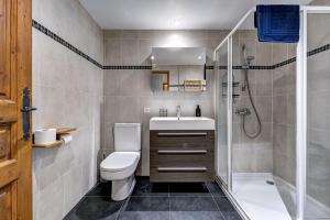 a bathroom with a toilet and a shower and a sink at Tiny Chalet - near to Servoz train station in Les Houches +28 photos