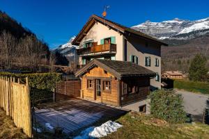 a house with a balcony on top of it at Tiny Chalet - near to Servoz train station in Les Houches