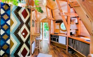 a kitchen in a tiny house with wooden walls at Les 7 Montagnes in Lourdes
