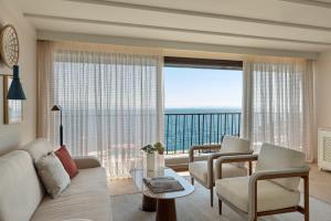 a living room with a couch and chairs and a large window at Amadria Park Grand Hotel 4 Opatijska Cvijeta in Opatija