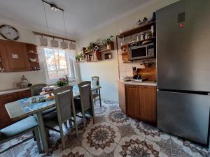 a kitchen with a table and a refrigerator at Mieszkanie przy plaży Ela in Dziwnów