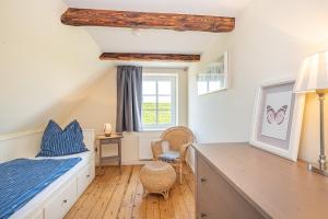 ein Schlafzimmer mit Bett, Schreibtisch und Fenster in der Unterkunft Elblounge in Grünendeich