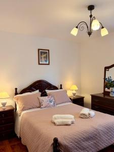 a bedroom with a bed with two towels on it at Vista do Pilar in Conceição