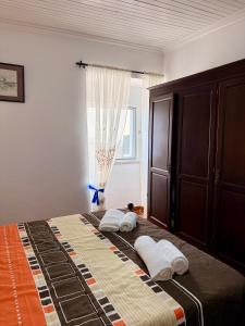 a bedroom with a large bed with two pillows on it at Vista do Pilar in Conceição