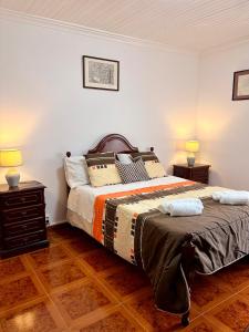 a bedroom with a bed with two night stands and two lamps at Vista do Pilar in Conceição