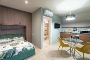 a bedroom with a bed and a table and chairs at La casa di Aurora in Pavia