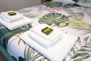 two towels sitting on top of a bed at La casa di Aurora in Pavia