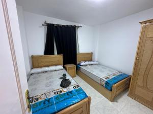 a room with two twin beds and a window at ريفيرا 1 in Ras Sedr +25 photos