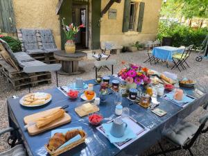 a blue table with food and bread and flowers on it at l'Estagnol in Ansouis