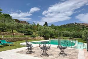 a villa with a swimming pool with chairs at Villa Montepulciano by Mmega in Montepulciano