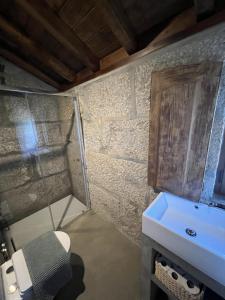 a bathroom with a sink and a toilet at Casa da eira in Santo Emilião