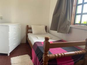 a small bedroom with a bed and a dresser at Pousada Cisne Branco in Natal +13 photos