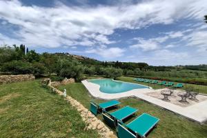 a swimming pool with lounge chairs and a pool at Villa Montepulciano by Mmega in Montepulciano