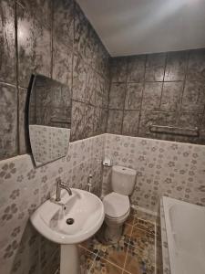 a bathroom with a sink and a toilet and a mirror at Libong haven in Ko Kwang