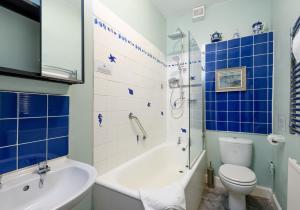 a bathroom with a tub and a toilet and a sink at Sandy Neuk in North Berwick +34 photos