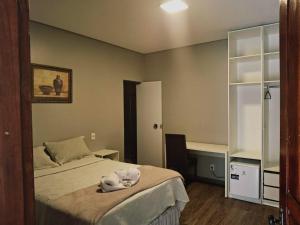 a bedroom with a bed with a hat on it at Mindú Park Hotel in Manaus