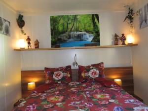 a bedroom with a bed with a view of a waterfall at Veluwe Park Reewold Chalet Infinity in Putten