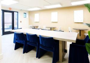 a conference room with a long table and chairs at Modern Midtown Studio and Private Balcony in Raleigh +10 photos