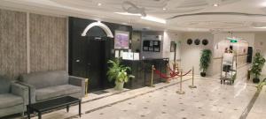 a lobby with a couch and plants in a building at Saad in Cairo
