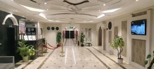 a hallway with plants and a ceiling with a red ribbon at Saad in Cairo