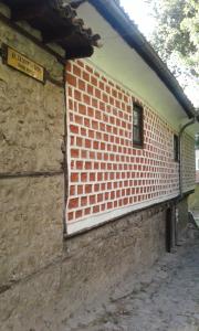 a brick building with a sign on the side of it at The Red Konak in Veliko Tŭrnovo