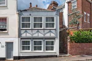 a house with a blue and white facade at Modern Cottage in Central Exeter in Dean