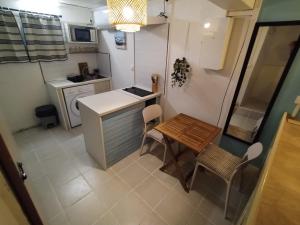 an aerial view of a small kitchen with a table and chairs at Lagoon Studio Appartement in Fort-de-France