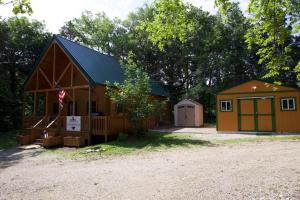 a barn with a garage and a house at Charlie Long Cabin - Active Heroes in Shepherdsville