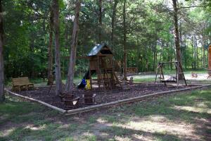 a park with a playground with a swing set at Charlie Long Cabin - Active Heroes in Shepherdsville +3 photos