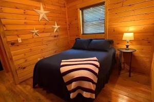 a bedroom with a bed with stars on the wall at Charlie Long Cabin - Active Heroes in Shepherdsville