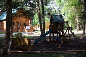 a park with a playground with a slide at Charlie Long Cabin - Active Heroes in Shepherdsville