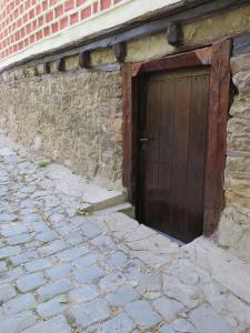 a wooden door on the side of a brick building at The Red Konak in Veliko Tŭrnovo