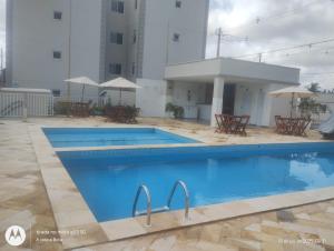 a swimming pool in front of a building at Ap no Turu, 10 min das praias in São Luís