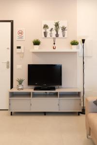 a living room with a flat screen tv on a entertainment center at Alloggio Viola - Gionic Apartments Bologna in Bologna