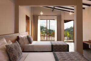 a hotel room with two beds and a balcony at Oak Ray Sky Terrace in Kandy +44 photos