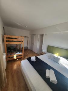 a bedroom with a large bed with two towels on it at What else guest house in Fátima +26 photos