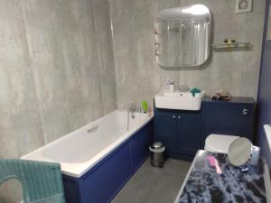 a bathroom with a tub and a sink and a toilet at Pankhurst, Louth in Louth +33 photos
