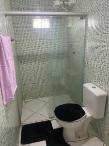 a bathroom with a glass shower with a toilet at Casa temporada in Arraial do Cabo +4 photos