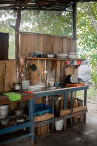 a table with pots and pans on top of it at Miguel Surf Camp in Quepos