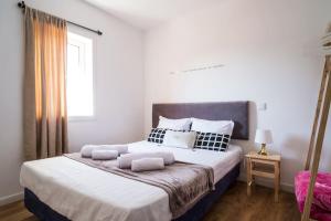 a bedroom with a large bed with two pillows at What else guest house in Fátima