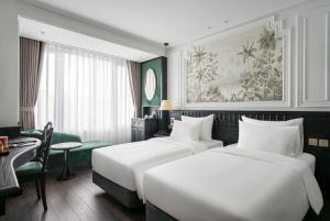 a hotel room with two beds and a desk at Luxe Paradise Suites Hotel & Spa in Hanoi +38 photos
