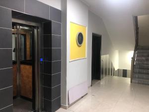 a hallway with a clock on a wall at Center Luxury Apartment in Tirana