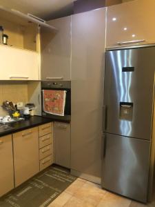 a kitchen with a stainless steel refrigerator at Center Luxury Apartment in Tirana