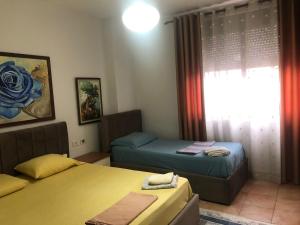 a room with two beds and a window at Center Luxury Apartment in Tirana
